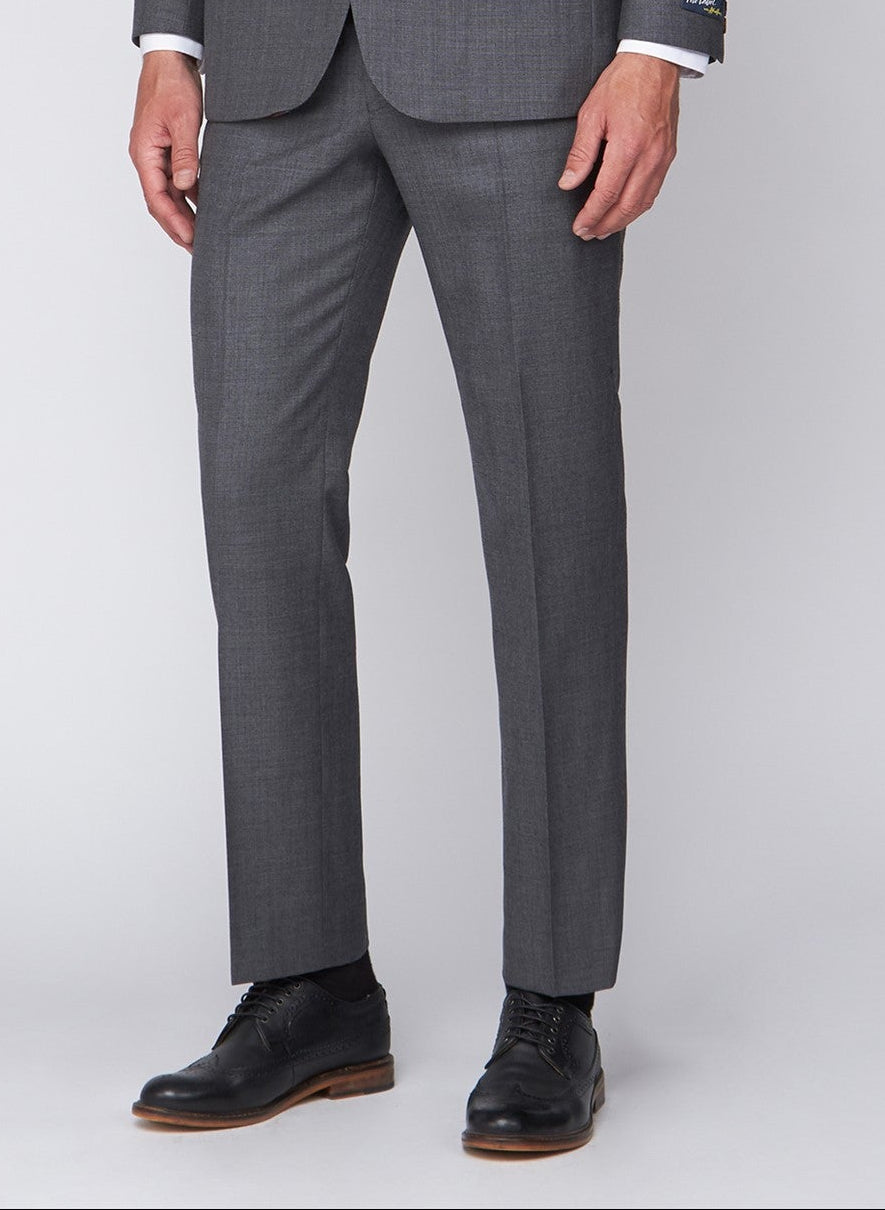 Gray suit pants worn with black shoes on a light gray background